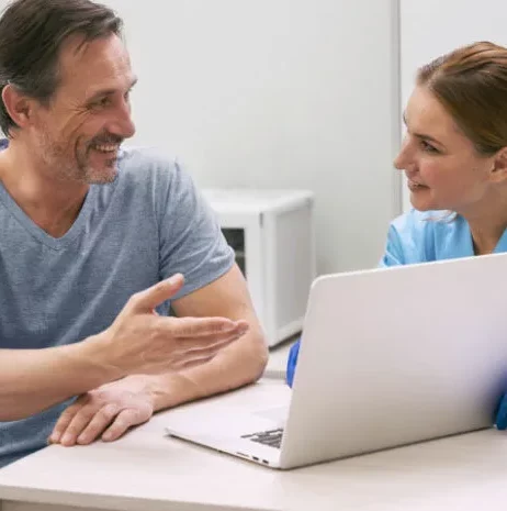 Healthcare professionals having discussion sitting infront of laptop