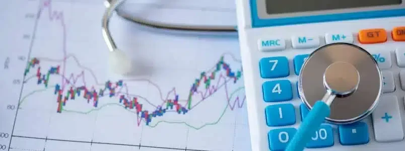 8-key-performance-indicators-kpis-every-cardiology-practice-should-track-for-rcm-suc A stethoscope rests on a calculator, symbolizing the intersection of healthcare and finance.