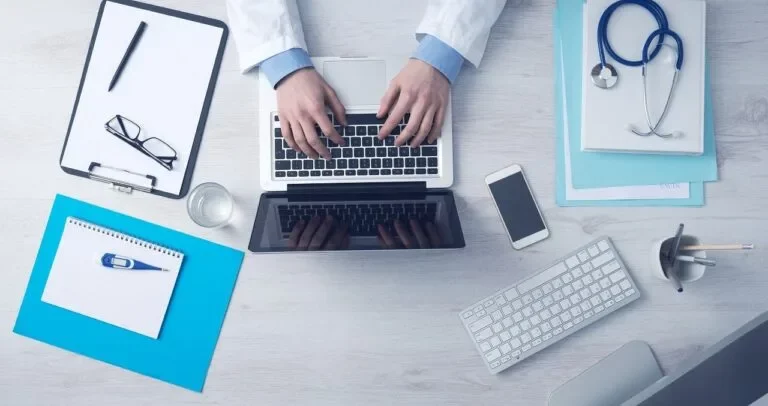 A Medical Practioner is using laptop concerning How to Start a New Medical Billing Business