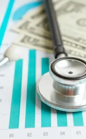 Maximizing-Revenue-Potential-image-p2-img A stethoscope is placed over cardiology billing reports